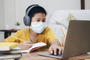 Boy wearing face masks online study at home.
