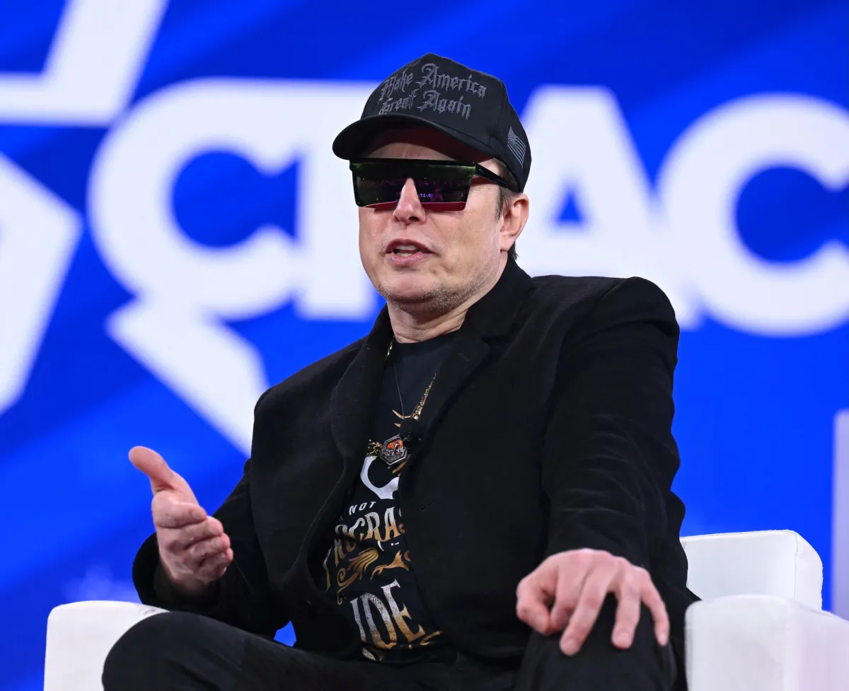 Elon Musk on stage discussing AI and Grok 4 alignment