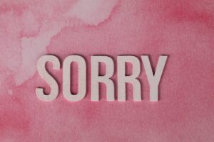 Text “SORRY” on pink background symbolizing xAI's public apology for Grok chatbot controversy