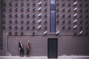 Wall with surveillance cameras symbolizing Meta’s unoriginal content policy enforcement