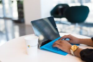 Person using Microsoft Surface device, symbolizing AI productivity and cost savings