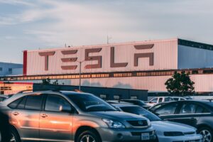 Tesla factory building with cars parked in front
