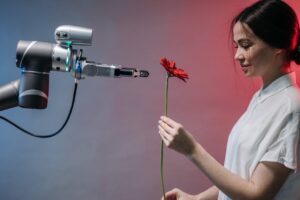 A robot arm offering a red flower to a smiling woman, symbolizing AI companionship.