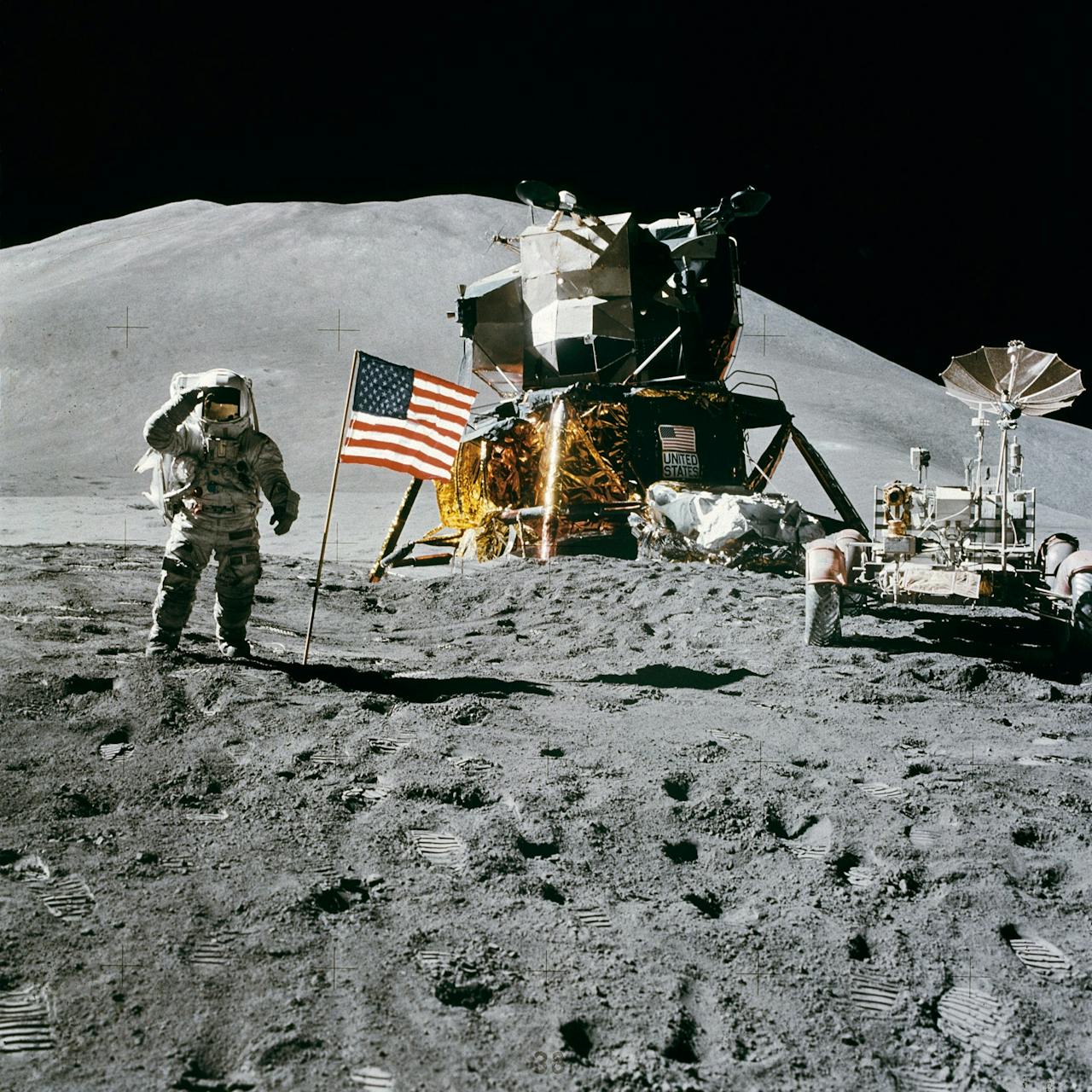 Astronaut on the Moon near lunar module and rover, symbolizing future lunar nuclear reactor exploration