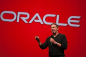Larry Ellison speaking at an Oracle event, symbolizing his media empire expansion into Paramount and TikTok.