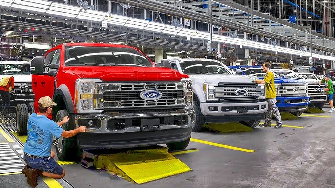 Ford F-150 Lightning production pause on an assembly line, showing gas and hybrid F-Series trucks being prioritized.