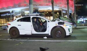 Waymo robotaxi vandalism incident in Los Angeles street at night