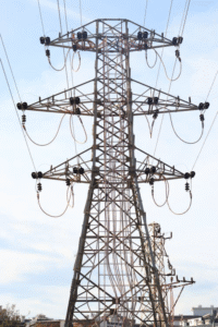 Electrical grid software demand surge illustrated by high-voltage transmission tower supporting modern power infrastructure