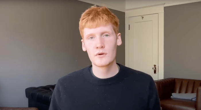 Young professional speaking on camera in a minimalist home office with natural lighting