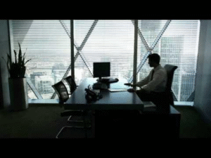 Corporate executive sitting alone in an office as AI layoffs narrative reflects investor-focused workforce decisions