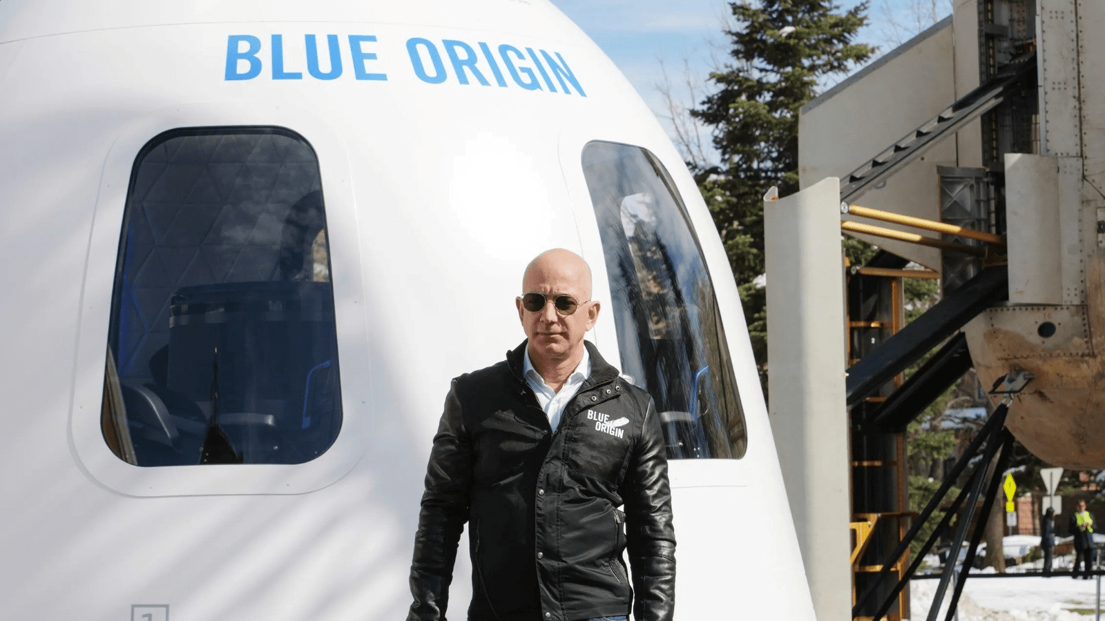 Blue Origin spacecraft with company executive standing in front during shift toward moon missions