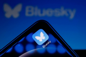 Bluesky app icon displayed on a smartphone, representing the platform’s transparency report and trust and safety enforcement