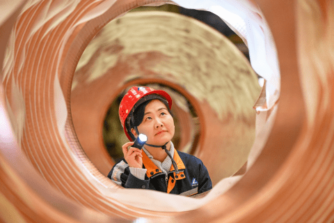 Inspector examining copper coil amid supply constraints driving copper’s biggest annual gain since 2009