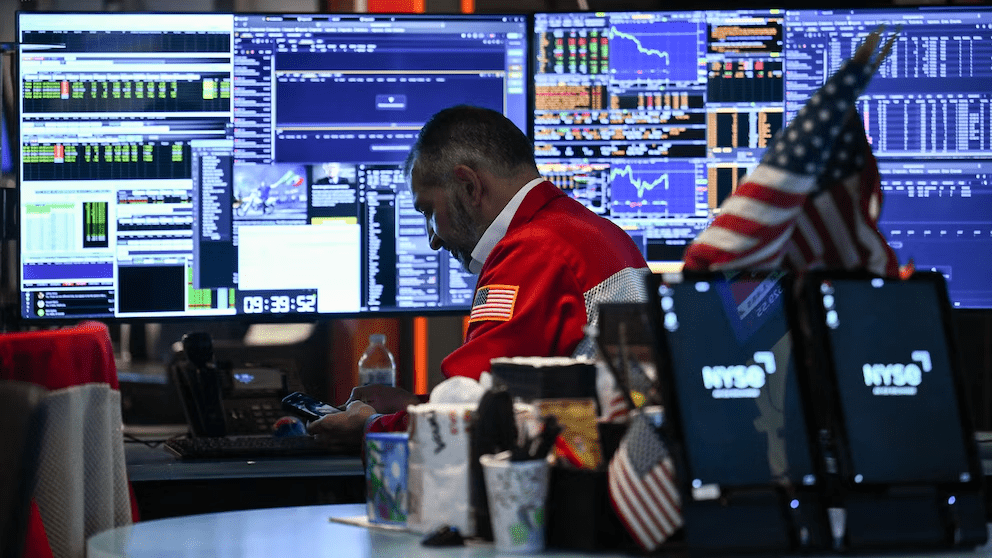 Trader monitors markets as crude oil prices rise after Maduro ouster