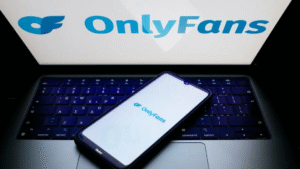 OnlyFans logo displayed on a smartphone and laptop screen, representing the platform amid talks of a majority stake sale to Architect Capital.