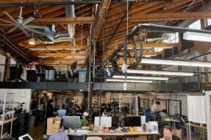 Open-plan robotics lab where engineers test general-purpose robot arms in a research-focused workspace
