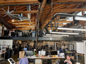 Open-plan robotics lab where engineers test general-purpose robot arms in a research-focused workspace