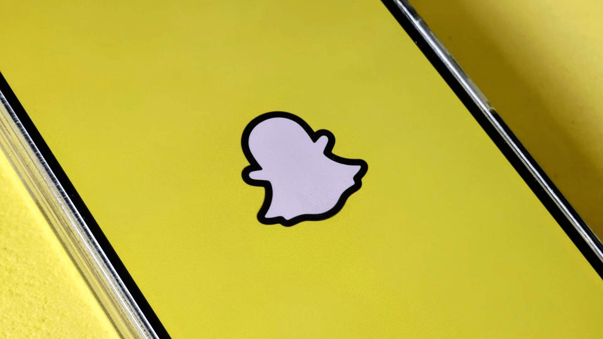 Snapchat logo displayed on a yellow background representing updates to parental controls and Family Center screen time insights