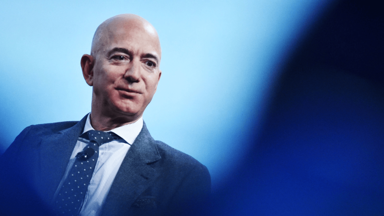 Technology company founder speaking during a public event amid record stock market gains