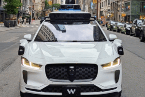 Waymo robotaxi operating on a city street following a school zone incident under federal investigation