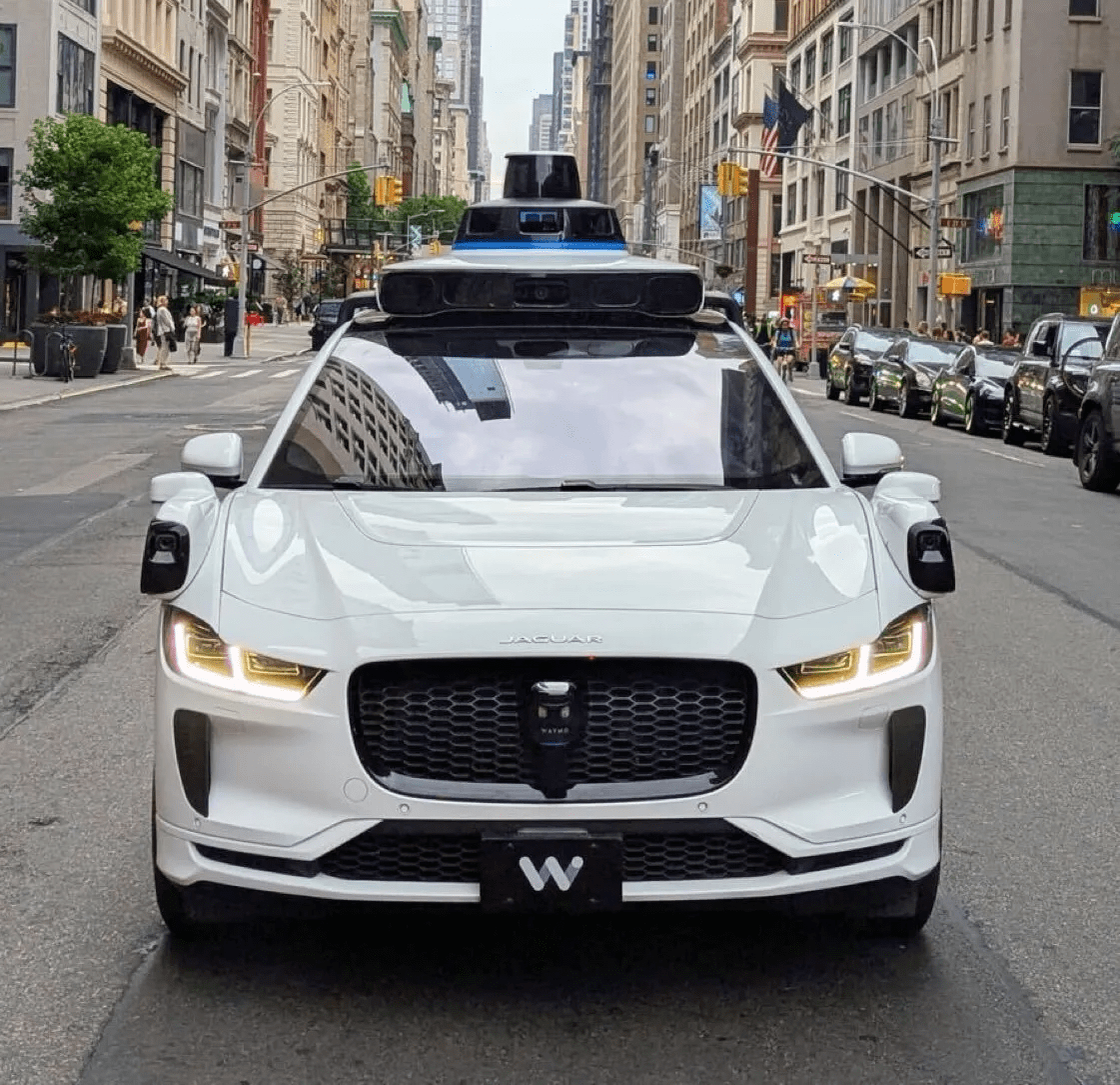 Waymo robotaxi operating on a city street following a school zone incident under federal investigation