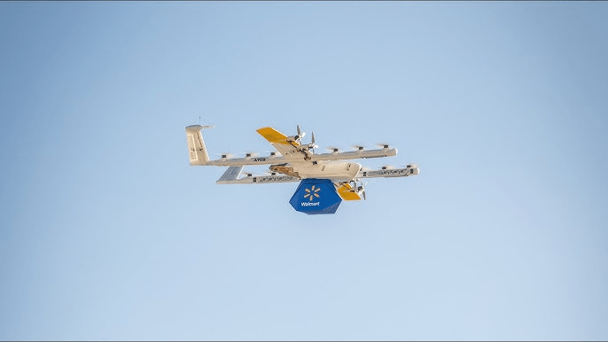 Wing drone carrying a Walmart package during on-demand drone delivery expansion